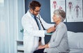 Assessing to ensure all is in check. a doctor examining a senior patient with a stethoscope in a clinic. Royalty Free Stock Photo