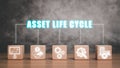 Wooden block on desk with asse life cycle icon on virtual screen