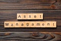 Asset management word written on wood block. Asset management text on wooden table for your desing, Top view concept Royalty Free Stock Photo