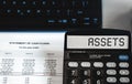 Assets - concept of text on calculator display. Top view Royalty Free Stock Photo