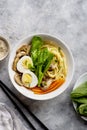Assian vegan soup. Soba noodles with a vegetable broth with mushrooms, eggs, carrots and choi sum leaves. Royalty Free Stock Photo
