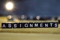 ASSIGNMENTS concept wooden blocks on the table.