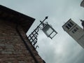 Assisi, Italy, December 1, 2007 Photo taken from an angle. Bottom up view of an old Italian tower and a beautiful metal street Royalty Free Stock Photo