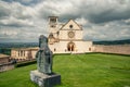 Classic view of famous Basilica of St. Francis of Assisi in beautiful spring day light with dramatic clouds in the sky