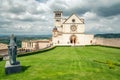 Classic view of famous Basilica of St. Francis of Assisi in beautiful spring day light with dramatic clouds in the sky