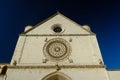 Church of San Francesco in Assisi with the stone wall. The basilica built in Gothic style houses the frescoes by Giotto