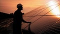 Assistance technical worker in uniform is checking an operation and efficiency performance of photovoltaic solar panels Royalty Free Stock Photo