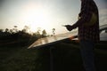 Assistance technical worker in uniform is checking an operation and efficiency performance of photovoltaic solar panels Royalty Free Stock Photo