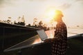 Assistance technical worker in uniform is checking an operation and efficiency performance of photovoltaic solar panels Royalty Free Stock Photo