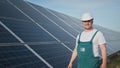 Assistance technical worker in uniform is checking an operation and efficiency performance of photovoltaic solar panels Royalty Free Stock Photo