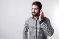 Assistance by telephone. The employee call center helps its customers over the phone. Bearded man isolated on white Royalty Free Stock Photo