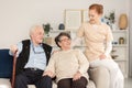 Assistance woman consoling senior couple