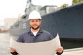 Assistant engineer reading documents and standing near vessel. Royalty Free Stock Photo