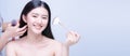 Assistant hands help to make hair salon for young asian woman with half naked applying cosmetic powder brush on smooth face, Royalty Free Stock Photo