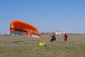 Assistant helps the paraglider to straighten the paraplane before the flight in Volgograd Royalty Free Stock Photo