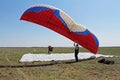 Assistant helps the paraglider to straighten the paraplane before the flight in Volgograd