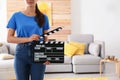 Assistant holding clapboard on film set. Space for text Royalty Free Stock Photo