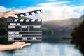 Assistant holding clapperboard, closeup. Cinema production