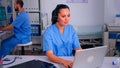 Assistant offering medical online services using headphone Royalty Free Stock Photo
