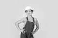 Assistant. Portrait of little girl with hard hat. Little girl in hard hat play in workshop. Child protection and safety