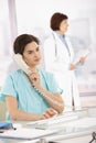 Assistant taking phone call for medical doctor Royalty Free Stock Photo