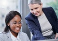 Assisting each other with some new plans. two businesswomen working together on a laptop in an office. Royalty Free Stock Photo