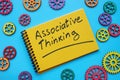 Associative thinking inscription on the notepad and cog wheels. Royalty Free Stock Photo