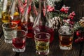 Assorted alcoholic cordials in glasses and decanters with Christmas decorations