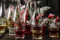 Assorted alcoholic cordials in glasses and decanters with Christmas decorations