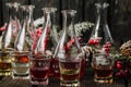 Assorted alcoholic cordials in glasses and decanters with Christmas decorations Royalty Free Stock Photo