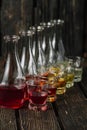 Assorted alcoholic cordials in glasses and decanters