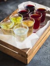 Assorted alcoholic cordials in a wooden box. Alcoholic drinks in restaurant