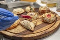 Assorted Argentine empanadas presented on a wooden tray and the chef\'s hands making up for the photo