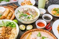 Assorted asian dinner, vietnamese food. Pho ga, pho bo, noodles, spring rolls top view