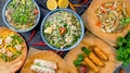 Pho ga, pho bo, noodles, spring rolls, salad with shrimps and mango on black stone table top view Royalty Free Stock Photo