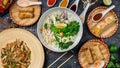 Assorted asian dinner, vietnamese food. Pho ga, pho bo, noodles, spring rolls Royalty Free Stock Photo