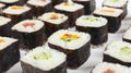 Assorted asian sushi on white background close up.