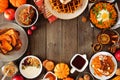 Assorted autumn breakfast or brunch items. Frame against a dark wood background with copy space.