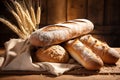 Assorted bakery items and wheat grains arranged on a table. A depiction of rustic, homemade bread and culinary delights
