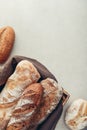 Assorted bakery products including loafs of bread, baguette and rolls in basket Royalty Free Stock Photo