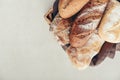 Assorted bakery products including loafs of bread, baguette and rolls in basket Royalty Free Stock Photo