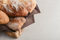 Assorted bakery products including loafs of bread, baguette and rolls in basket Royalty Free Stock Photo