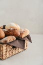 Assorted bakery products including loafs of bread, baguette and rolls in basket Royalty Free Stock Photo