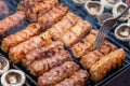 Assorted barbecue of meat rolls or mici and champignon mushrooms Royalty Free Stock Photo