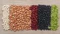 Assorted beans and lentils are arranged in horizontal stripes on a wooden Royalty Free Stock Photo