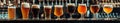 Assorted Beer Glasses Lined on Bar Counter Royalty Free Stock Photo