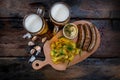 Assorted beer snacks with beer mugs