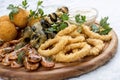 Assorted beer snacks. Cheese balls, mussels grill, shrimp, squid rings Royalty Free Stock Photo