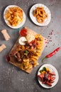 Assorted beer snacks: chips, sausages, onion rings, chicken nuggets, croutons, smoked ribs, chicken wings, tomato and garlic sauce Royalty Free Stock Photo