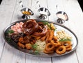 Assorted beer snacks. Sausages, croutons, fried onion rings, shrimps Royalty Free Stock Photo